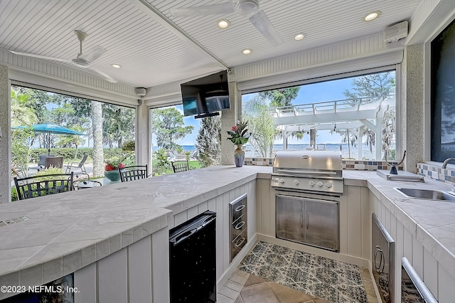 kitchen featuring wood ceiling, sink, ceiling fan, and fridge