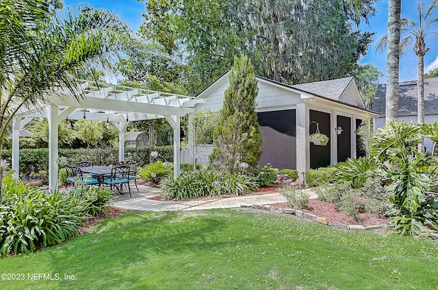 view of yard with an outdoor structure, a patio, and a pergola