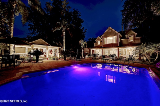 view of pool at night