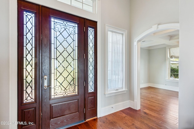 entrance foyer with beamed ceiling, dark hardwood / wood-style floors, and coffered ceiling