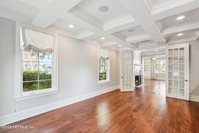 unfurnished living room featuring hardwood / wood-style floors, beamed ceiling, ornamental molding, and coffered ceiling