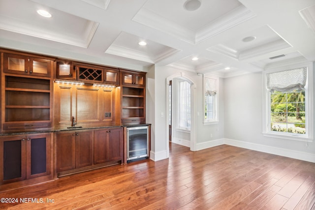 bar featuring hardwood / wood-style flooring, coffered ceiling, crown molding, and beverage cooler