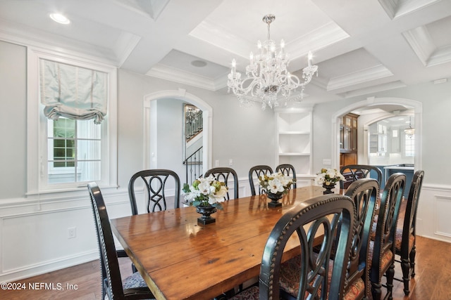 dining area with ornamental molding, an inviting chandelier, dark hardwood / wood-style floors, and coffered ceiling