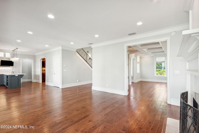 unfurnished living room with ornamental molding and dark hardwood / wood-style floors