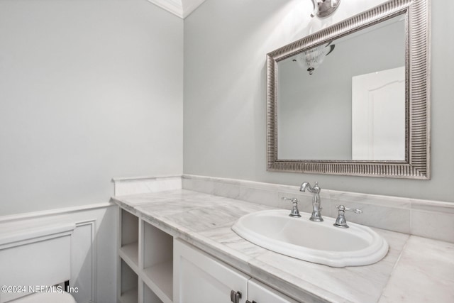 bathroom with vanity with extensive cabinet space and toilet