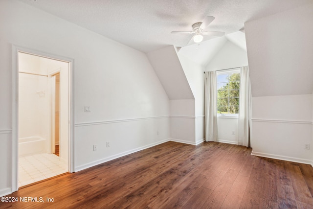 additional living space with dark wood-type flooring, ceiling fan, and vaulted ceiling