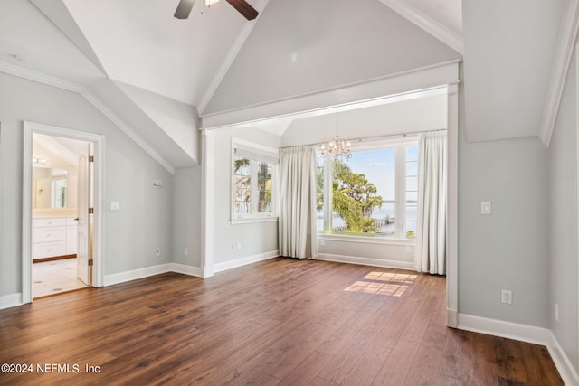 interior space with ceiling fan with notable chandelier, ornamental molding, dark hardwood / wood-style floors, and vaulted ceiling