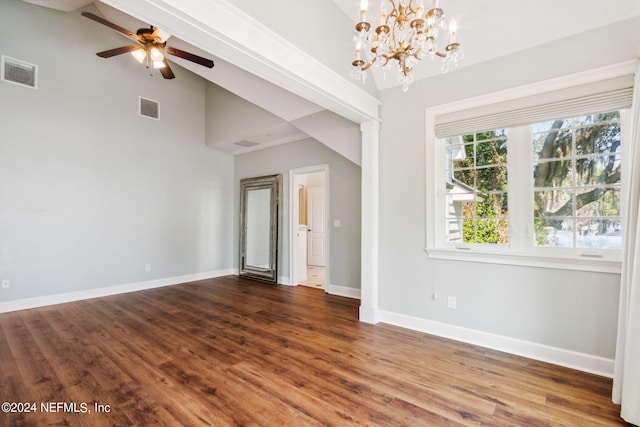 empty room with hardwood / wood-style flooring, high vaulted ceiling, and ceiling fan with notable chandelier