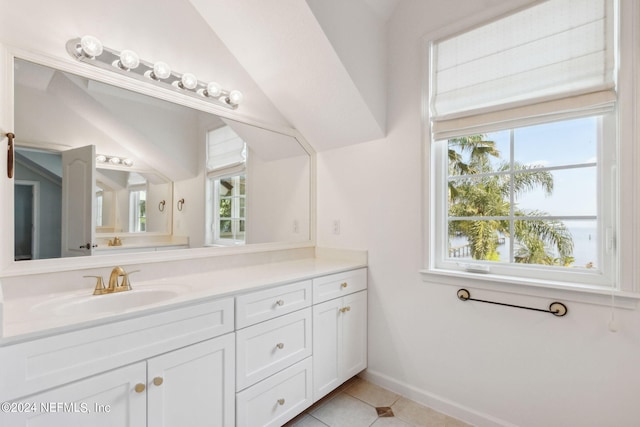 bathroom with lofted ceiling, vanity, and tile floors