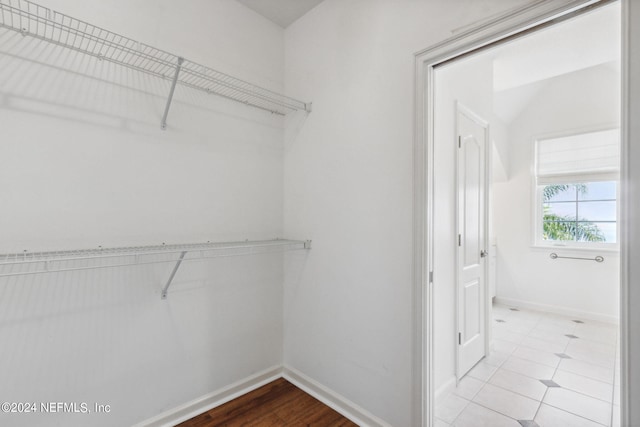 spacious closet with tile floors