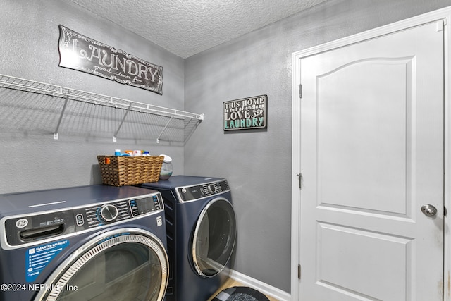 laundry area featuring independent washer and dryer and a textured ceiling