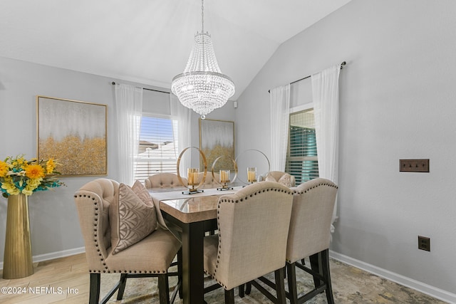 dining area featuring vaulted ceiling, hardwood / wood-style flooring, and a notable chandelier