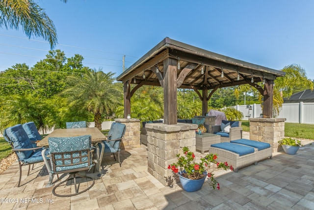 view of patio with an outdoor living space and a gazebo