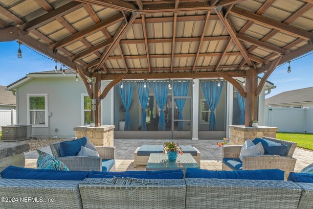 view of patio featuring an outdoor living space and a gazebo