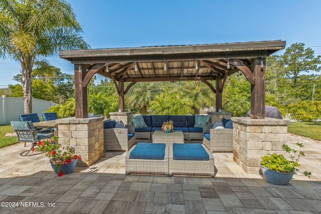 view of terrace with an outdoor living space and a gazebo