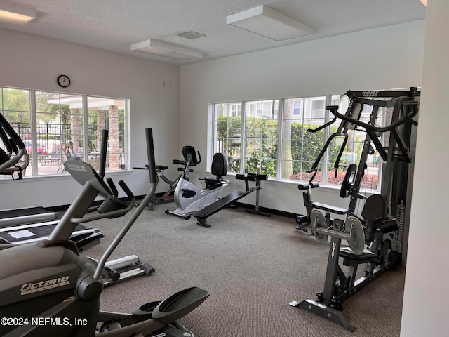 gym featuring a textured ceiling