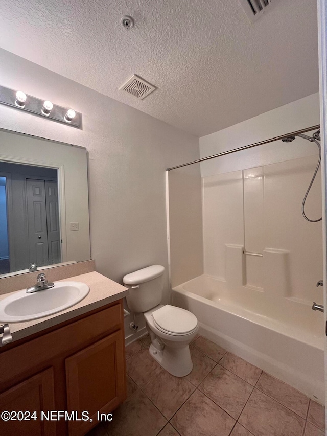 full bathroom with vanity, shower / washtub combination, a textured ceiling, and toilet