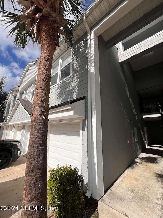 view of side of home featuring a garage