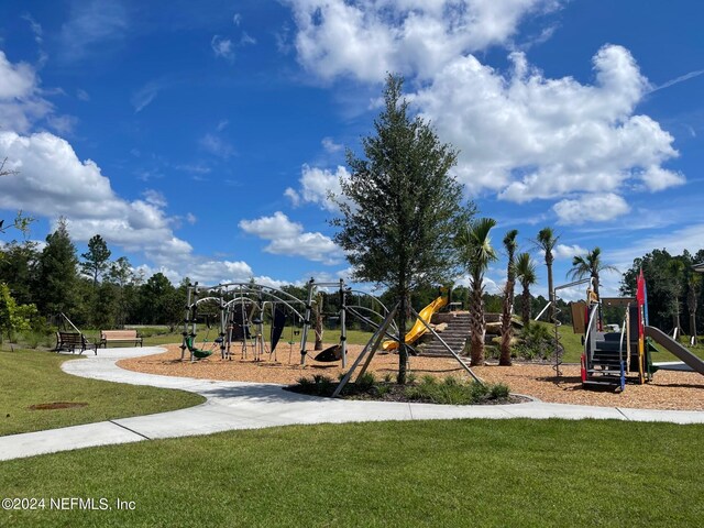 view of jungle gym featuring a lawn