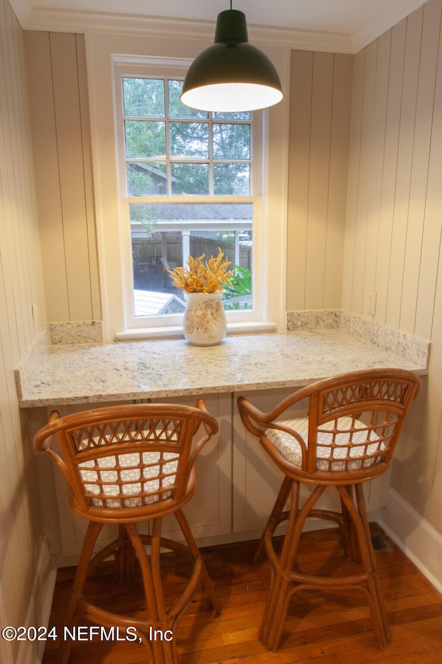 dining area with ornamental molding and wood-type flooring