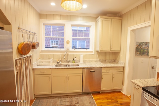 kitchen featuring sink, dishwasher, crown molding, and light hardwood / wood-style flooring