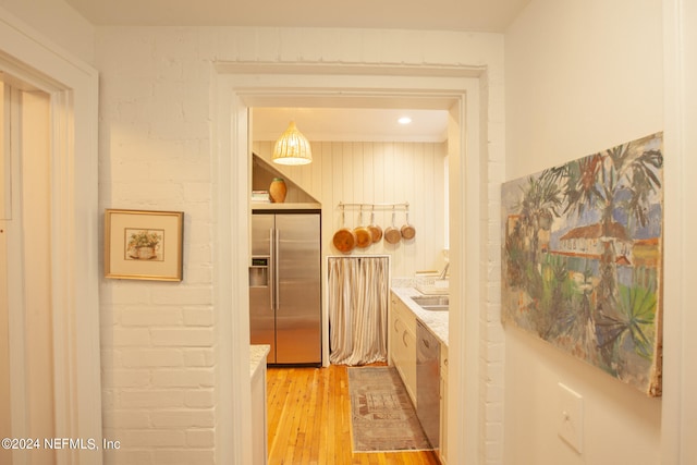 hall with sink and light hardwood / wood-style floors