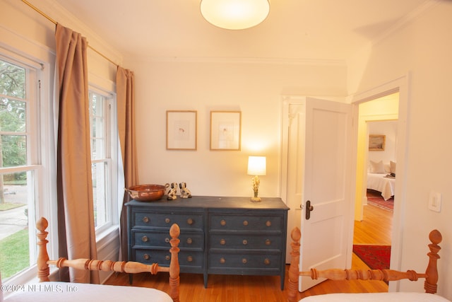 bedroom with crown molding and hardwood / wood-style flooring