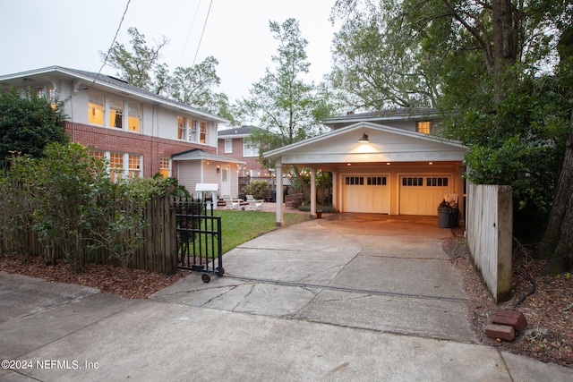 view of front of property featuring an outdoor structure, a carport, and a garage