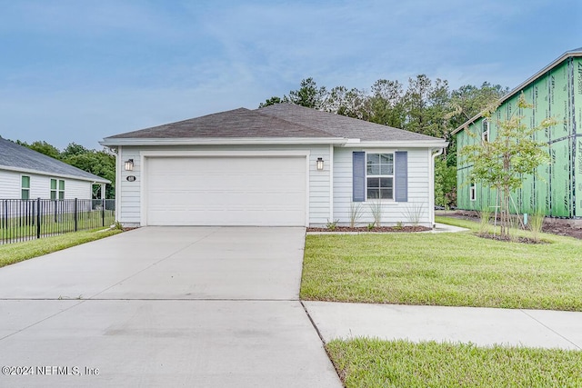 view of front of house featuring a front yard and a garage