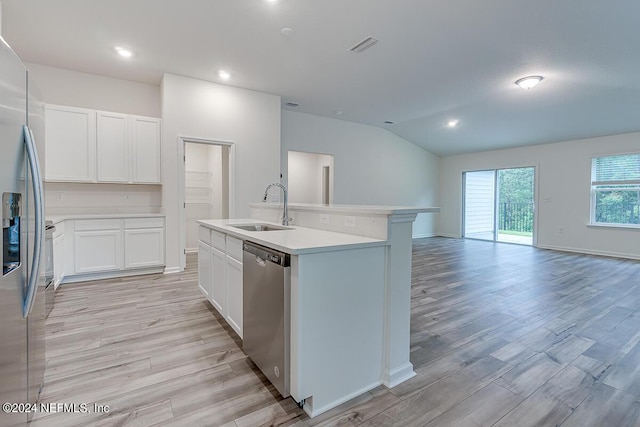 kitchen featuring white cabinetry, stainless steel appliances, an island with sink, sink, and light hardwood / wood-style flooring