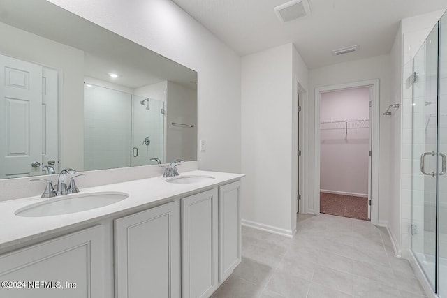 bathroom with vanity, tile patterned flooring, and walk in shower