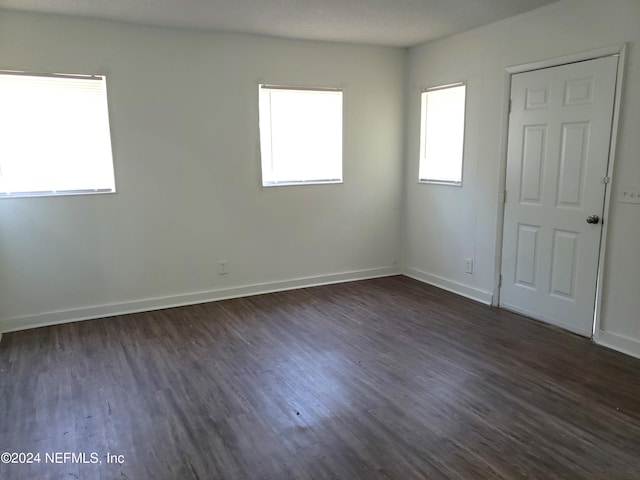 unfurnished bedroom featuring dark wood-type flooring