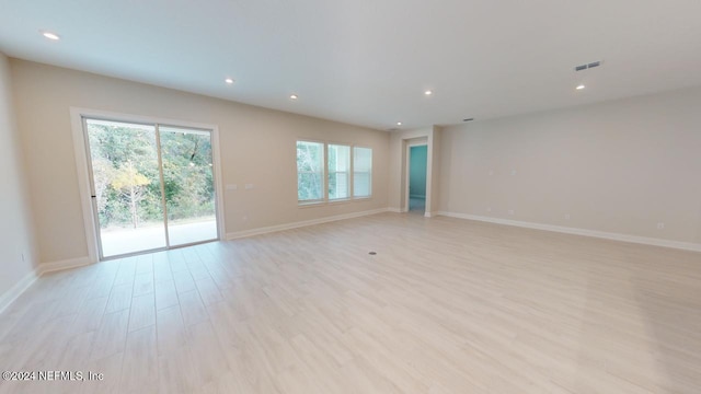 empty room with light hardwood / wood-style flooring