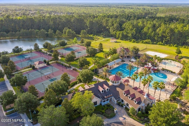 bird's eye view with a water view and a wooded view