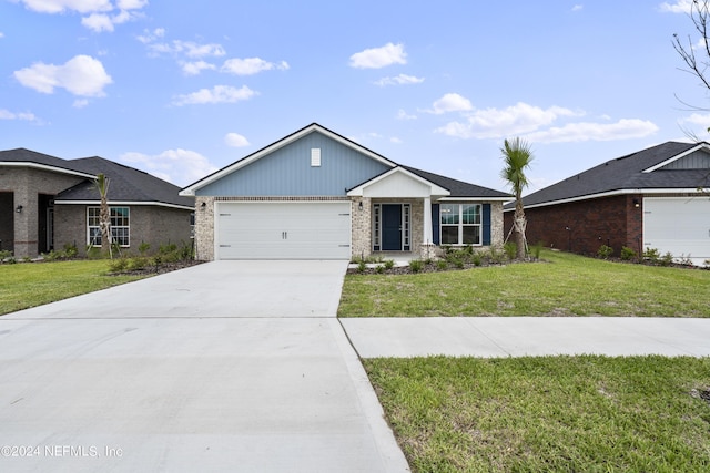 view of front facade with a front yard, concrete driveway, and an attached garage