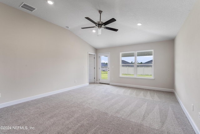 unfurnished room with light carpet, baseboards, visible vents, and lofted ceiling