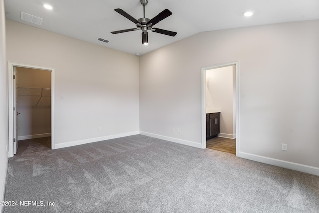 unfurnished bedroom with visible vents, a spacious closet, and carpet flooring