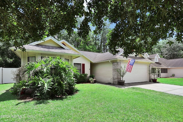 view of front of property with a garage and a front lawn