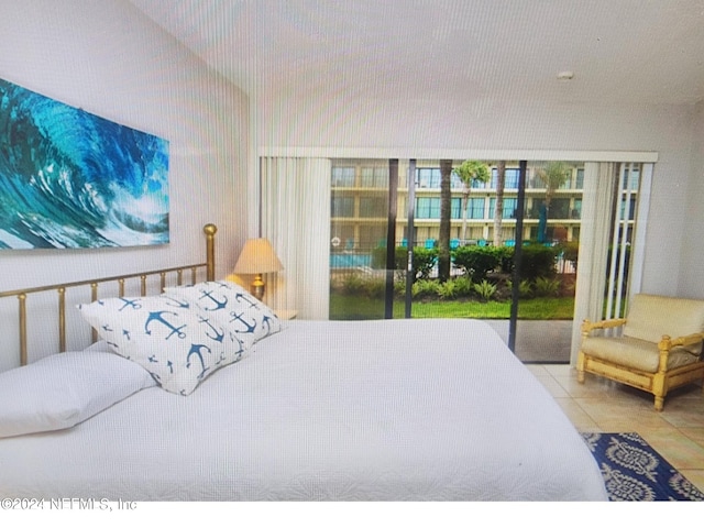 bedroom with access to outside, multiple windows, and tile patterned flooring