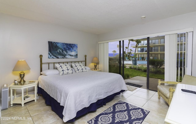 bedroom featuring access to outside and tile patterned flooring