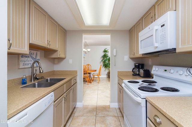 kitchen with white appliances, light brown cabinetry, a chandelier, light tile patterned floors, and sink