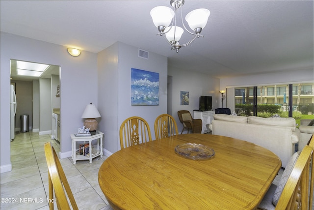 dining room with light tile patterned floors, baseboards, visible vents, and an inviting chandelier