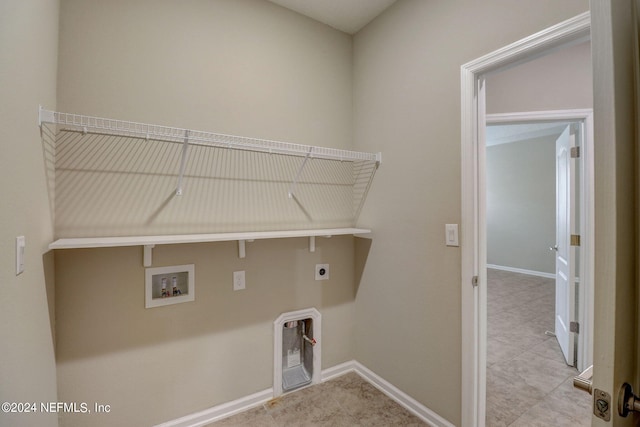 washroom with hookup for an electric dryer, tile floors, and hookup for a washing machine