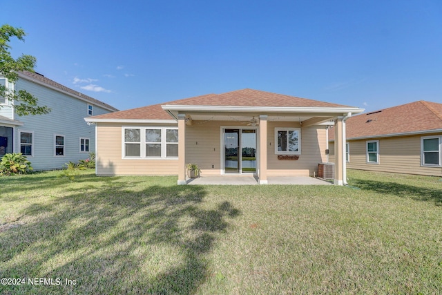 back of property with a patio area and a lawn