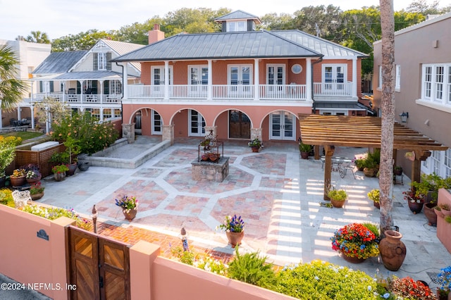 view of front facade featuring a balcony and a patio