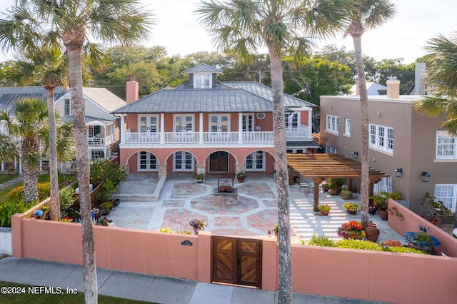 view of front of house featuring a patio and a balcony