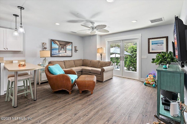 living room with hardwood / wood-style floors, ceiling fan, and french doors