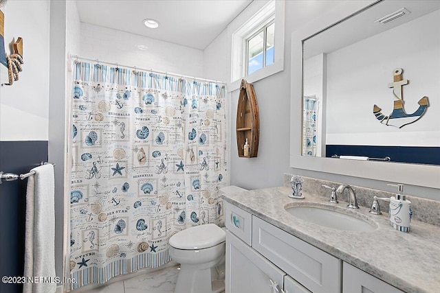 bathroom featuring toilet, tile flooring, and vanity