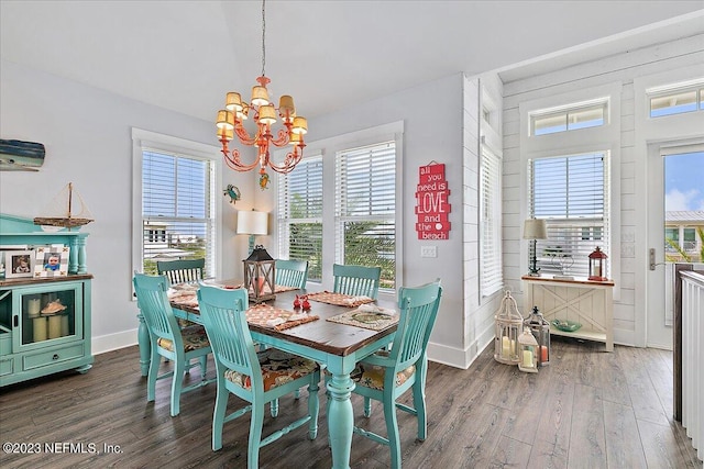 dining space featuring a notable chandelier and dark wood-type flooring