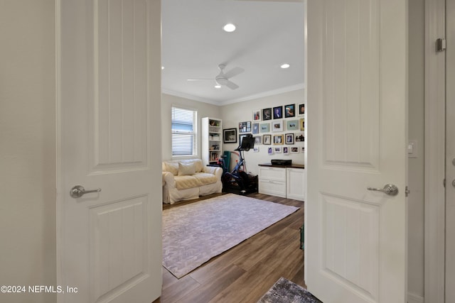 bedroom featuring wood-type flooring, ceiling fan, and ornamental molding